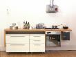 Small Modern Urban Apartment Kitchen, Small Bar Style Worktop And Moveable Drawers by Richard Powers Limited Edition Print