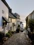 Cobbled Lane In Clovelly Fishing Village, North Devon, England by Adam Burton Limited Edition Print