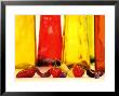 Various Types Of Peppers In Front Of Red & Yellow Bottles by Monica Varella Limited Edition Pricing Art Print