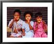 Three Children Eating Icy-Poles, Bengali Basti, Delhi, India by Daniel Boag Limited Edition Print