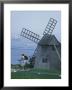 Bicyclist Rides Past A Windmill On A Cape Cod Shore, Chatham, Massachusetts by Darlyne A. Murawski Limited Edition Print