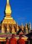 Three Young Monks Standing In Front Of Pha That Luang, Vientiane, Vientiane Prefecture, Laos by Alain Evrard Limited Edition Print