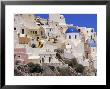 Village Of Oia With Blue Churches And Colourful Dwellings, Oia, Santorini (Thira), Greece by Marco Simoni Limited Edition Print
