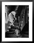 Housewife Cleaning Her Carpet With Vacuum Cleaners by Yale Joel Limited Edition Print