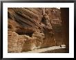 A Hiker Is Dwarfed By The Sandstone Walls Of A Utah Canyon by Dugald Bremner Limited Edition Print