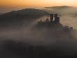 Sea Of Mist Swirls Around The Base Of Corfe Castle At Dawn, Corfe, Dorset, United Kingdom by Adam Burton Limited Edition Print