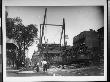 Boys And Well-Dressed Men Standing Near The Construction Site For An Elevated Train Bridge by Wallace G. Levison Limited Edition Print