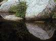 Granite Boulders Reflected In A Calm Mountain Lake by Stephen Sharnoff Limited Edition Print