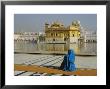 A Pilgrim In Blue Sits By The Holy Pool Of Nectar At The Golden Temple, Punjab, India by Jeremy Bright Limited Edition Print