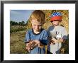 Two Young Kids Look At A Plains Leopard Frog, Greenleaf, Kansas by Joel Sartore Limited Edition Print