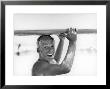 Freckled Surfer Larry Shaw Carrying Surfboard On His Head by Allan Grant Limited Edition Print