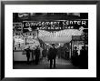 Sailors And Civilians Outside A Brightly Lit Times Square Arcade During Wwii by Peter Stackpole Limited Edition Print