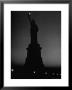 Silhouette Of Statue Of Liberty Lit By Two 200 Watt Lamps During Wartime Effort To Conserve Energy by Andreas Feininger Limited Edition Pricing Art Print