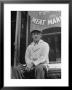 Butcher Taking A Break, Sitting In Front Of Meat Market by Ed Clark Limited Edition Print