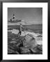 Man Fishing Off Montauk Point. Montauk Lighthouse Visible In Background by Alfred Eisenstaedt Limited Edition Print