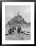 American Travelers Building A Sand Replica Of France's Medieval Abbey At Mont Saint Michel by Yale Joel Limited Edition Print