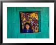 Little Girl In The Window Of Her Brightly Painted House, Ciudad Melchor De Mencos, Guatemala by Jeffrey Becom Limited Edition Print