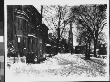 Next To A Sled After A Heavy Snowstorm With A Church And Victorian-Style Homes by Wallace G. Levison Limited Edition Print