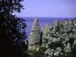 Climber Atop A Limestone Rock Face, Sardenia Italy by Michael Brown Limited Edition Print