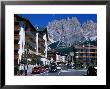 Apartment Buildings With Cliffs Of Cristallo Group Behind, Cortina, Veneto, Italy by Grant Dixon Limited Edition Print