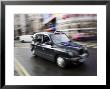 London Cab Traveling Through Traffic On A Rainy Day, England, London by Eightfish Limited Edition Print