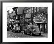 Cars Parked In Front Of Four Navy Uniform Stores On Sand Street by Andreas Feininger Limited Edition Pricing Art Print