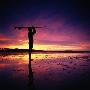 Surfer Standing On Beach At Sunset by Philip Lee Harvey Limited Edition Pricing Art Print