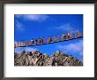 Hikers Crossing Steel Suspension Bridge Over Crevasse, Wolchulsan National Park, South Korea by Martin Moos Limited Edition Print