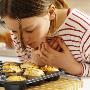 A Little Girl Inhaling The Scent Of Freshly Baked Cup Cakes by Niclas Albinsson Limited Edition Print