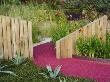 Mediterranean Style Garden With Wooden Walls, Gravel, Hemerocallis And Agaves, Pink Path by Clive Nichols Limited Edition Print