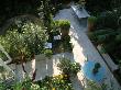 View Onto Small Garden With Italian Hard Limestone Floor And Table by Clive Nichols Limited Edition Print