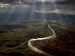 Crepuscular Rays Of Sunlight Shine Over A Snaking River by Randy Olson Limited Edition Print