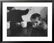 Tired Child Is Ready To Go To Sleep With His Head On The Dining Room Table At Ellis Island by Alfred Eisenstaedt Limited Edition Print