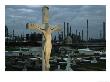 A Petrochemical Plant Looms In The Background Behind A Stone Crucifix by Ira Block Limited Edition Print