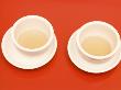 Close-Up Of Two Tea Cups On Red Table For Chinese Tea Ceremony by Images Monsoon Limited Edition Pricing Art Print