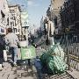 Man On A Streetside Fence By Some Rubbish by Shirley Baker Limited Edition Pricing Art Print