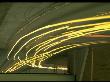 Streaking Car Lights In Lines Of White, Straight And Curving Off On Exit, At Night On Highway by Ralph Crane Limited Edition Print