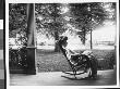 Mrs. Franklin S. Brady Sitting In A Wicker Rocking Chair On The Porch Of Her Home by Wallace G. Levison Limited Edition Print