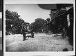 A Black Man Driving A Cart Pulled By Three Mules Down Main St by Wallace G. Levison Limited Edition Pricing Art Print