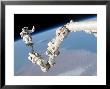 Astronaut Anchored To A Foot Restraint On The International Space Station's Canadarm2 by Stocktrek Images Limited Edition Pricing Art Print