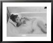 Unexposed Nude Woman In The Bathtub Amid The Bubbles While Smoking A Cigarette by Peter Stackpole Limited Edition Print