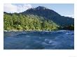 A Mountain Peak Looms Over The Aqua Water Of The Futaleufu River by Skip Brown Limited Edition Print