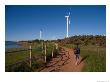 A Man Walks Along A Path Near Wind Turbines by Taylor S. Kennedy Limited Edition Print