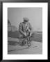 Humorous Of Man Riding Tiny Bicycle by Wallace Kirkland Limited Edition Pricing Art Print