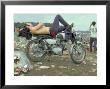 Shirtless Man In Levi Strauss Jeans Lying On Motorcycle Seat At Woodstock Music Festival by Bill Eppridge Limited Edition Print