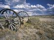 Abandoned Wagon Wheels Beside Road by Oote Boe Limited Edition Print