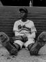 Baseball Player Satchel Paige Sitting Alone On The Ground, Resting His Sore Feet by George Silk Limited Edition Pricing Art Print