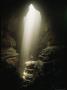 Natural Light Illuminates A Person Standing The Bottom Of A Cave by Stephen Alvarez Limited Edition Print