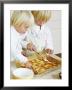 Two Children Brushing Biscuits With Glace Icing by Renate Forster Limited Edition Pricing Art Print