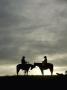 Cowboy And Cowgirl On Horseback In Silhouette At Sunset by Scott Stulberg Limited Edition Print